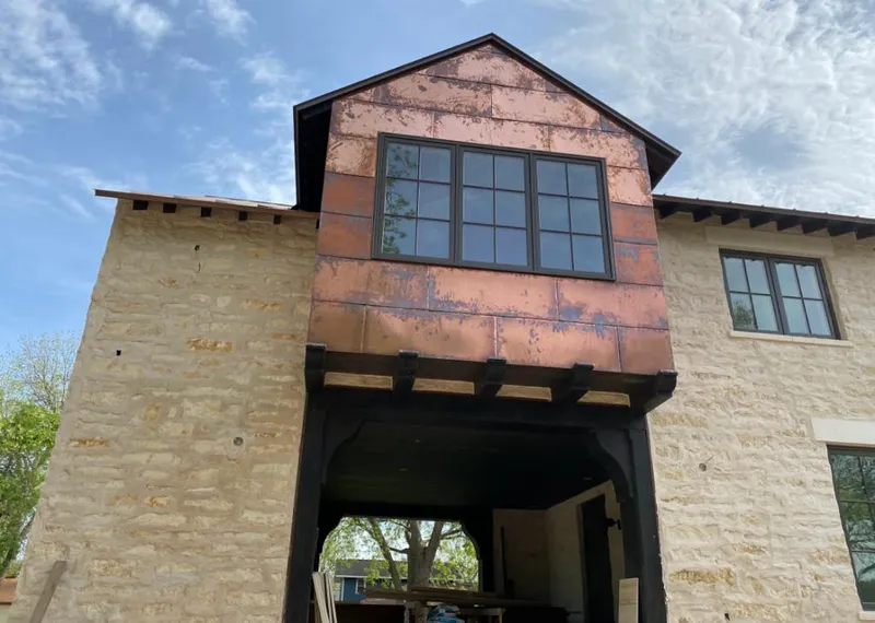 Copper metal panel facade on a stone building for Skylight Installation in Haines City