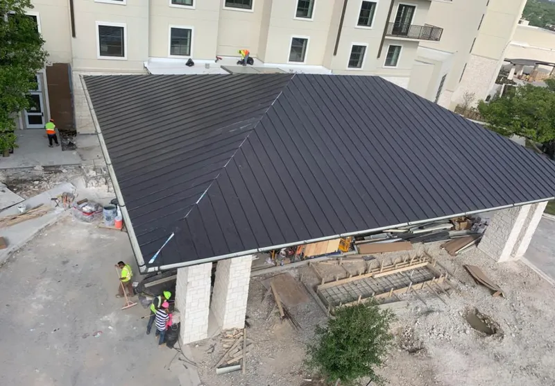 Metal roofing installation team working on a commercial building in Haines City